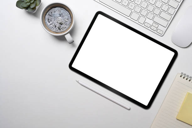 istock Flat lay digital tablet, coffee cup, notebook and succulent plant on white table. 1396799101