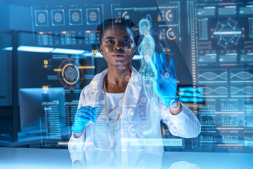 A young African - American doctor works on HUD or graphic display in front of her, we see her from the waist up in a modern laboratory