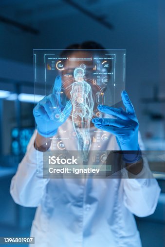 istock A small HUD with a human body image and a scientist or a doctor, working with it 1396801907