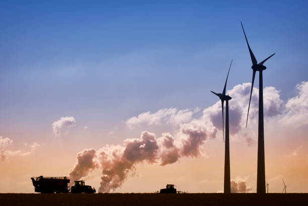 istock Wind energy and tractors versus coal fired power plants 1396805314