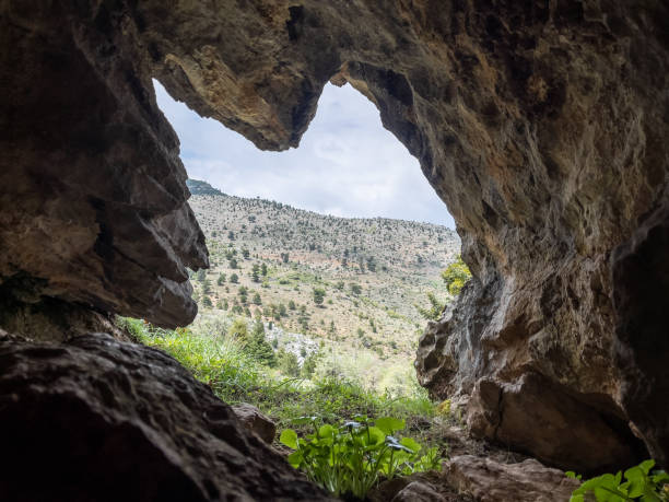 istock cave with mountain view and nature view 1396805704