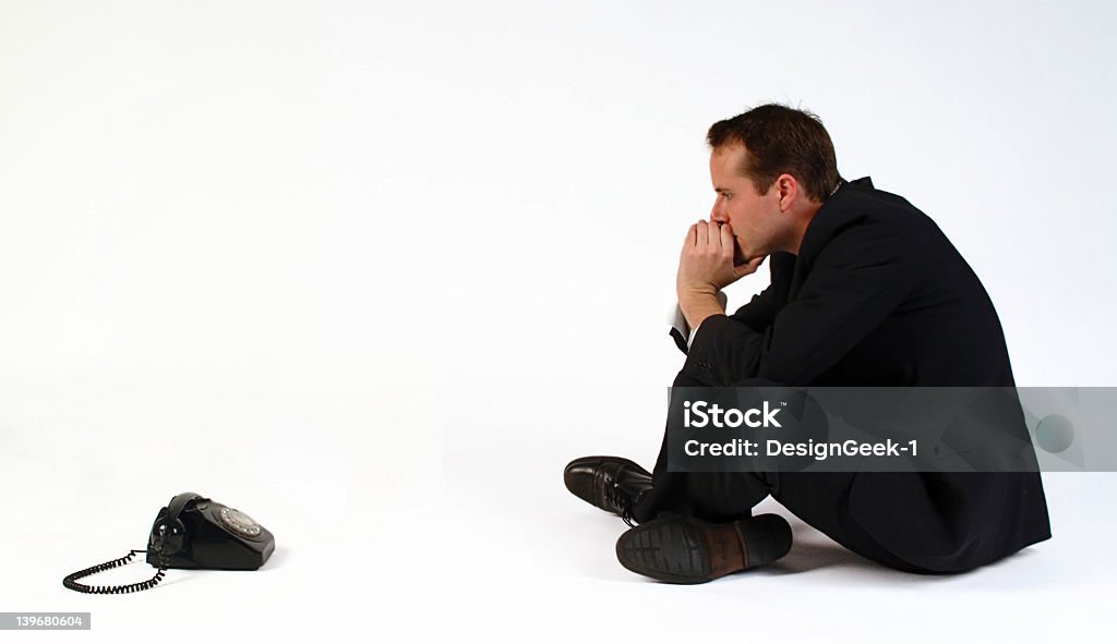 Man watching the phone waiting on an expected call  Business man waiting for a call. Business Stock Photo