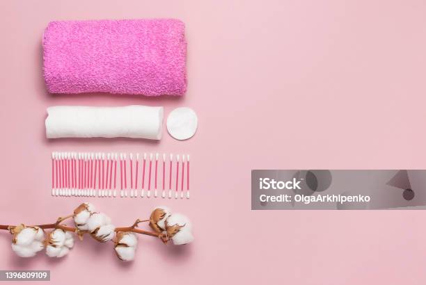 Spa Concept Flat Lay Background With Cotton Branch Cotton Pads Eared Sticks Pink Towel Cotton Cosmetic Makeup Removers Tampons Hygienic Sanitary Swabs On The Pink Background Top View Copy Space Stock Photo - Download Image Now
