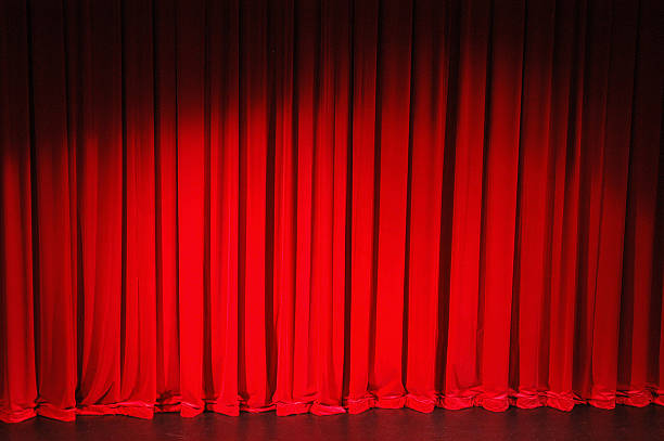 Red stage curtain lowered to stage stock photo