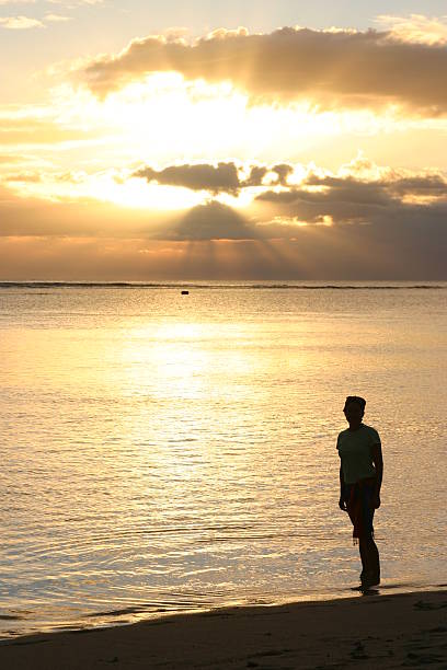 istock Silhoutte of woman standing on a beach 139681038