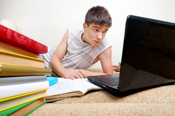istock Annoyed Teenager doing Homework 1396810775