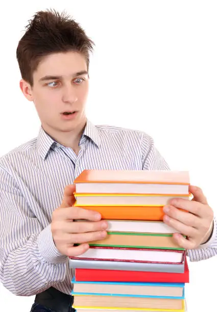 Surprised Teenager looking on the Books Isolated on the White Background
