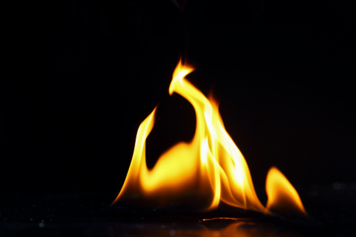 the beautiful flames of a gas fire isolated against a black background. 