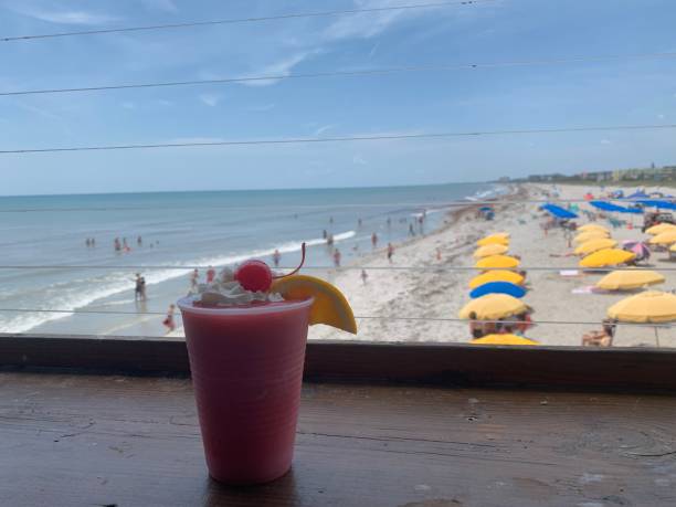 A frozen strawberry margarita with the Cocoa Beach coastline in the background A frozen strawberry margarita with the Cocoa Beach coastline in the background. A frozen tropical drink on a sunny day overlooking the beach. cocoa beach stock pictures, royalty-free photos & images