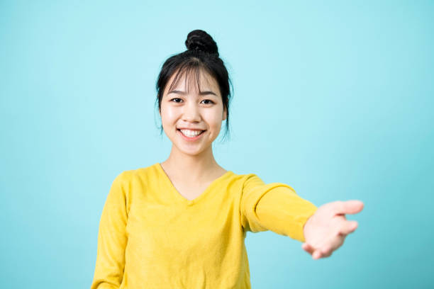 istock Young woman holds out hand in greeting 1396815555