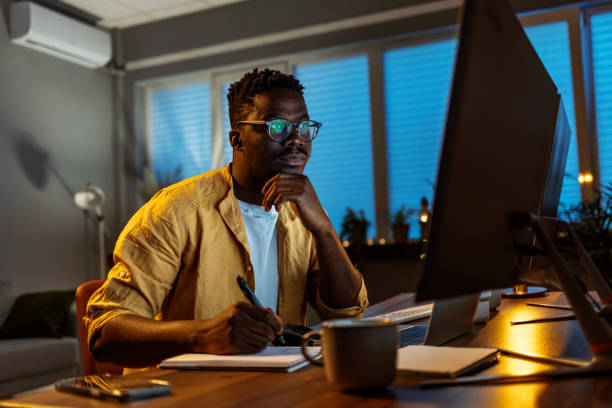 istock Shot of a handsome young man writing in a notebook 1396815781