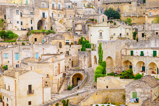 The stunning maze of alleys, stairs and stone houses in the old town of Matera, in southern Italy, known worldwide as the 'Sassi di Matera' (Matera's Stones). The ancient city of Matera, in the region of Basilicata, is one of the oldest urban settlements in the world, with a human presence that dates back to more than 9,000 years ago, in the Paleolithic period. The Matera settlement stands on two rocky limestone hills called 'Sassi' (Sasso Caveoso and Sasso Barisano), where the first human communities lived in the caves of the area. The rock cavities have served over the centuries as a primitive dwelling, foundations and material for the construction of houses, roads and beautiful churches, making Matera a unique city in the world. In 1993 the Sassi of Matera were declared a World Heritage Site by Unesco. Image in High Definition format.