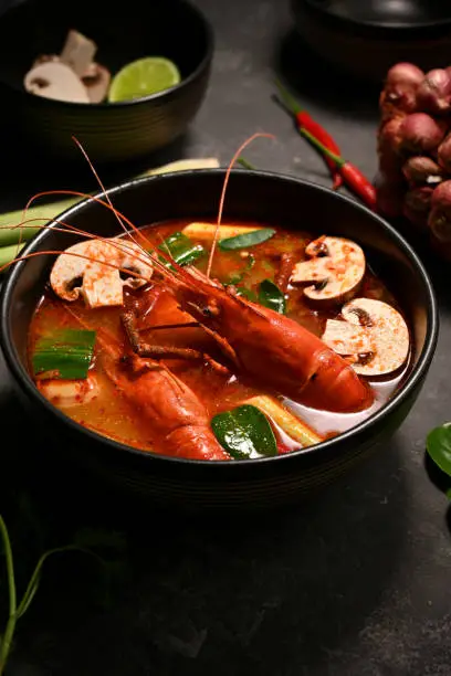 Photo of Delicious Tom Yam Kung or Thai spicy coconut milk soup with shrimps.