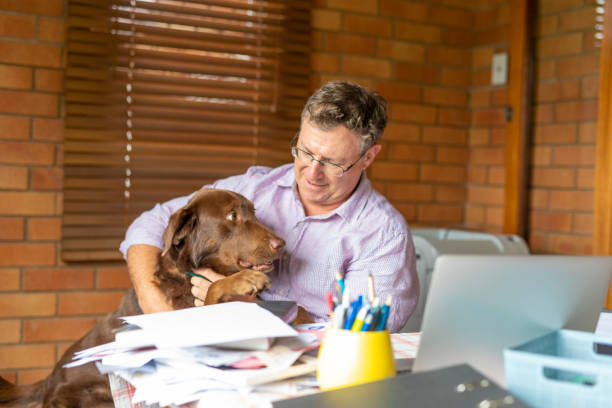 istock Middle aged man working from home with his dog 1396817592