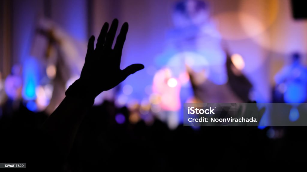Hand raising concert, Hand raising for religion silhouette hands Praising - Religion Stock Photo
