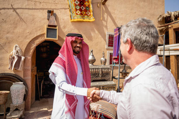 Visiting businessman connecting with Middle Eastern merchant