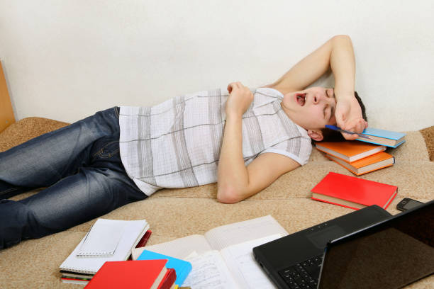 istock Tired Teenager yawning on Sofa 1396819102