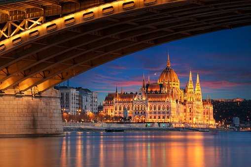 Cityscape image of Budapest, capital city of Hungary with Margaret Bridge and Hungarian Parliament Building at sunset.