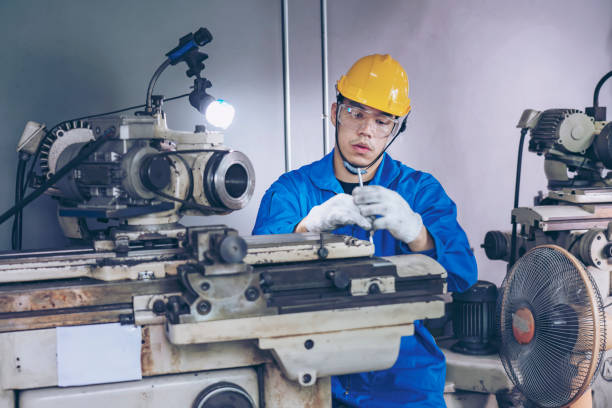 istock Finishing metal working on high precision CNC grinding machine in workshop. 1396820155