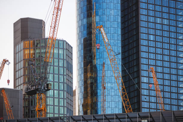 Construction site in business district of Frankfurt am Main with cranes operating on new buildings, development and modernization