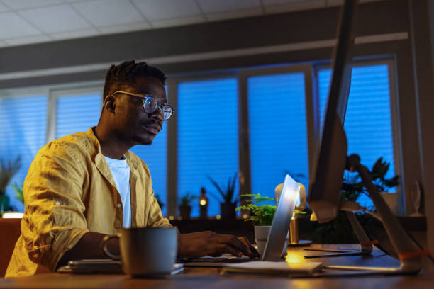 istock Man doing office work till late at night at home 1396821165
