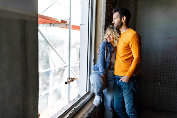 istock Happy couple in love embracing at construction site. 1396823211