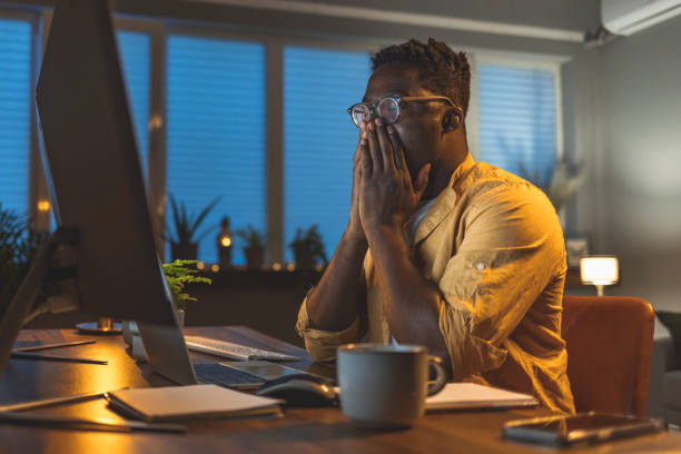 istock Worried man looking at computer screen in office 1396823234