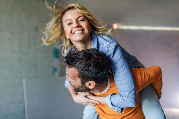 istock Happy couple having fun while piggybacking during home renovation process. 1396824091