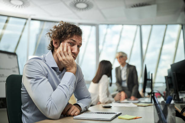 istock Bored businessman at corporate office. 1396824465