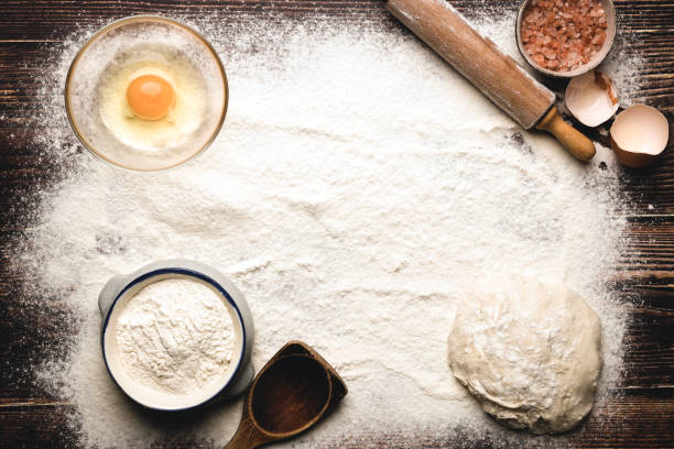 istock Bread ingredients and utensils on wood frame background 1396824603