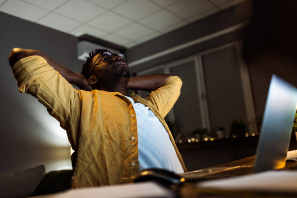 tired man in home office - bending over backwards imagens e fotografias de stock