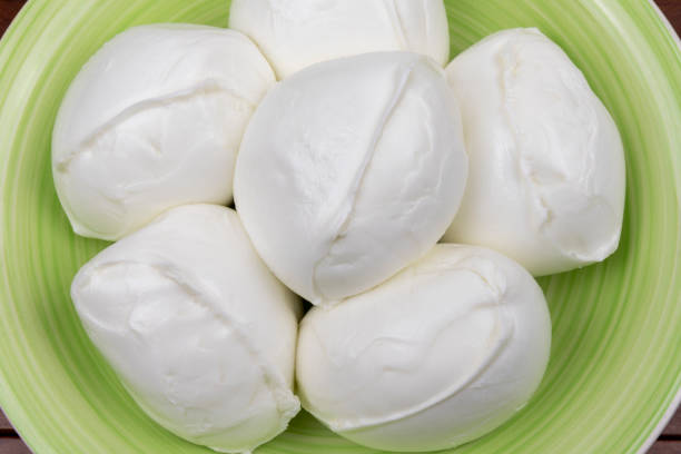 istock Buffalo mozzarella (mozzarella di bufala) on the plate. Flat lay. Close-up. Mozzarella from Campania DOP. 1396830048