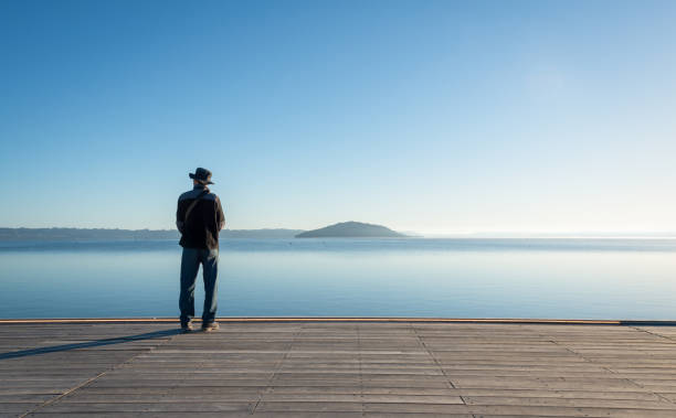 istock Man standing on the lakefront boardwalk, Rotorua. 1396831670