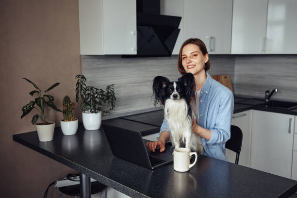 istock Woman working from home with her dog 1396833199