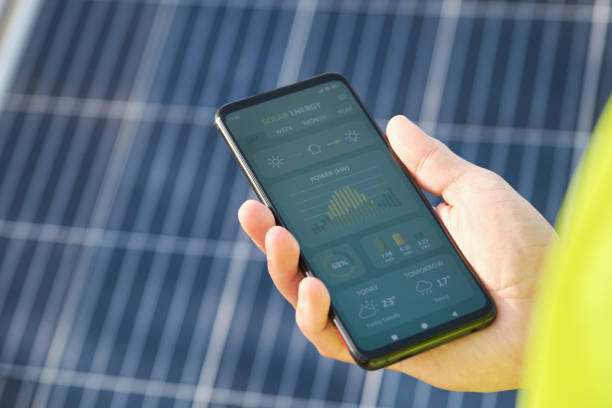 istock Hand showing a solar power generation smartphone app. 1396834404