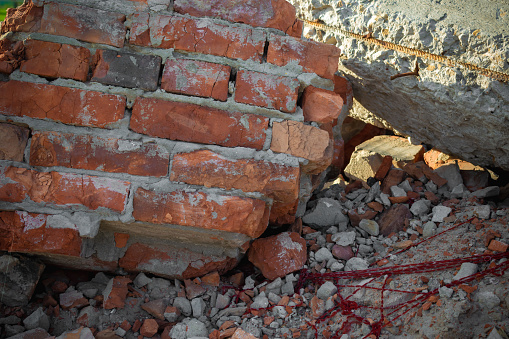 Close-up of the destroyed building. Fragments of red brick and reinforced concrete floors.
