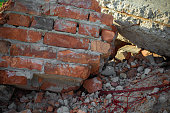 Close-up of the destroyed building. Fragments of red brick and reinforced concrete floors