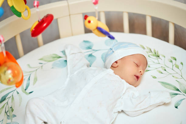 istock adorable new born baby sleeping in bed 1396835272