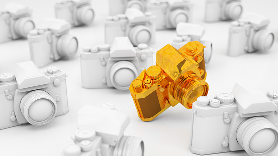Golden Photo Camera with White Replicas. 3D Render