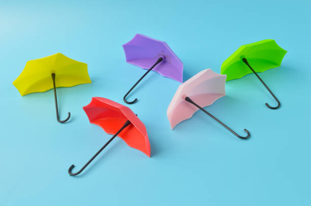 istock Colorful toy umbrella isolated on a blue background 1396836397
