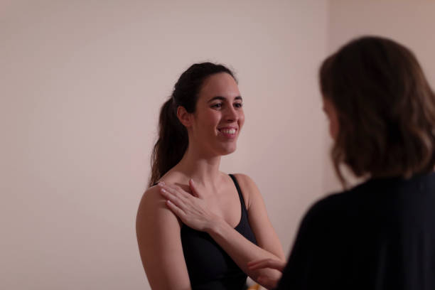 istock A woman therapist examines her patient's shoulder 1396837893