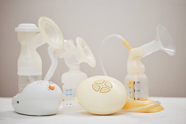 istock different breast pumps on table. Maternity and child care. 1396838191