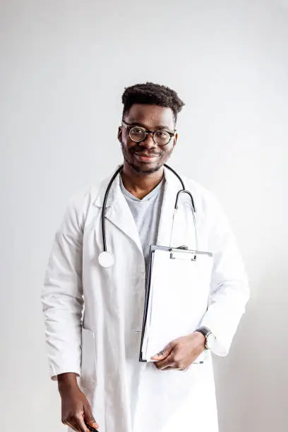 Photo of Portrait of happy african doctor at private clinic