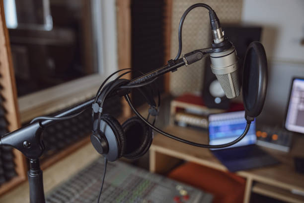 istock Focus on professional microphone and headphones in the blurred soud engineer workplace 1396841590