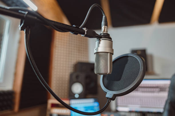 istock Soft focus on professional microphone in the workplace for broadcasting. Music rehearsal space. Sound recording studio 1396841772
