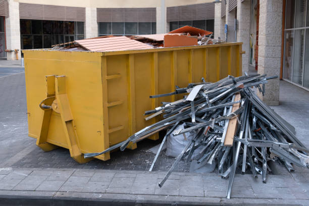 istock Huge heap on metal Big Overloaded dumpster waste container filled with construction waste, drywall and other rubble near a construction site. 1396843186