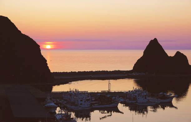 istock Sunset over Utoro Harbor and Triangular Rock, Shiretoko World Heritage Site, June 1396844063