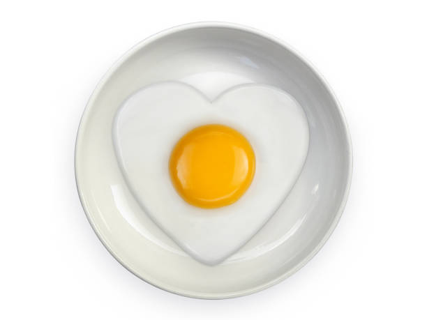 istock Heart-shaped omelet  fried egg on ceramic plates isolated on white background 1396844713