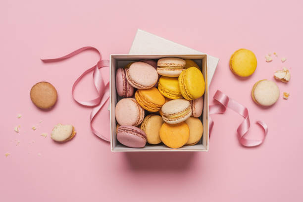 istock Macaroons almond biscuits in  gift box on pink pastel background 1396844733