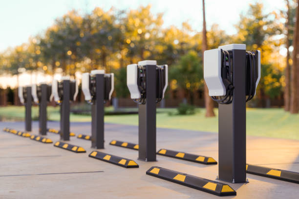 Electric Car Charging Station In Outdoor Parking Lot Electric Car Charging Station In Outdoor Parking Lot battery charger stock pictures, royalty-free photos & images